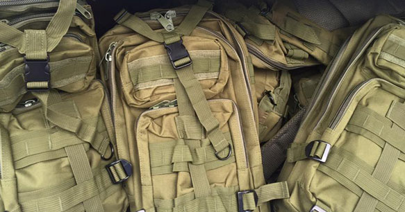 Military packs stacked on top of each other.