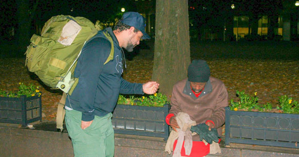 Homeless person sitting on a bench.